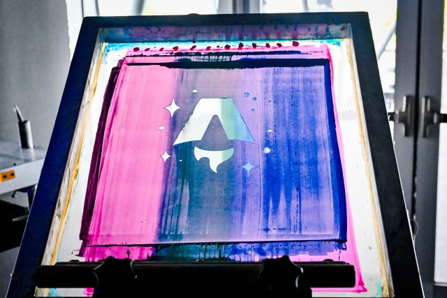 T-shirt printing press with the Astro logo design.