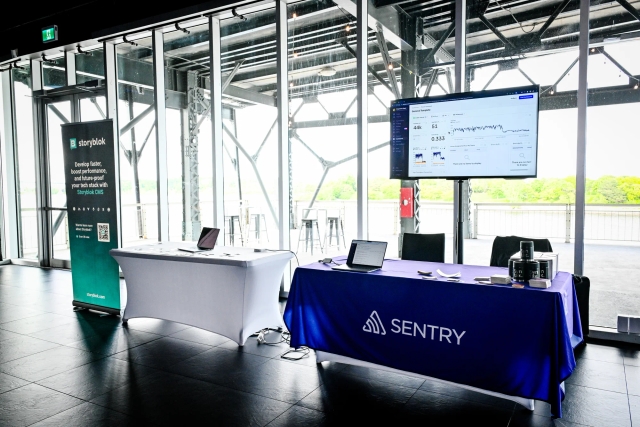 Sponsor booths for Storyblok and Sentry.