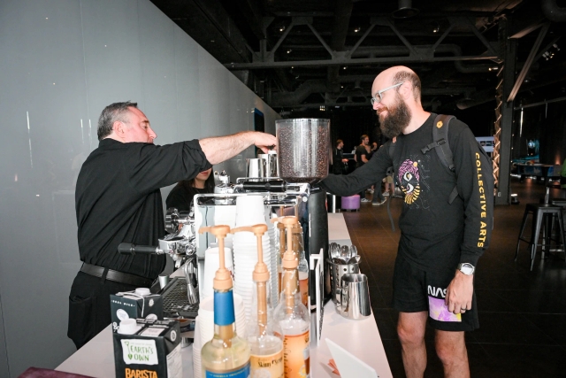 A guest putting in their coffee order at the coffee bar.