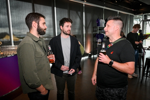 Guests talking and drinking with one another.