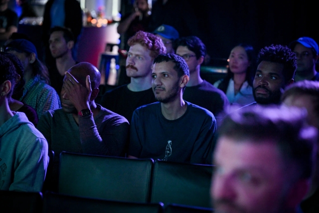 A shot of the crowd listening to Ben Holmes speak on stage.