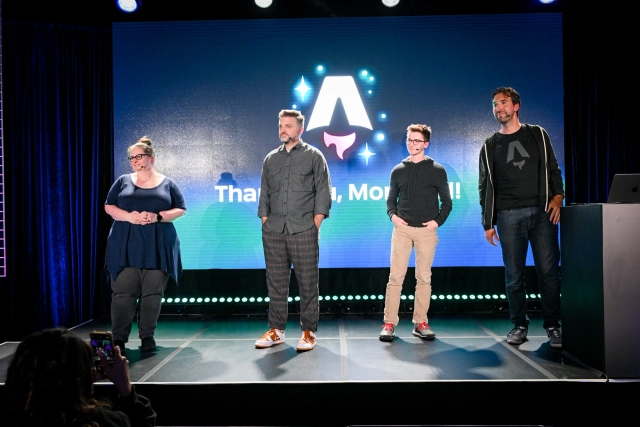 Keynote speakers on stage. From left to right: Sarah Rainsberger, Matthew Phillips, Ben Holmes, and Fred K. Schott (next to the podium).