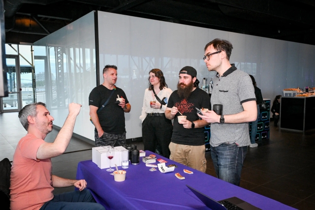 Guests speaking to Sentry at their sponsor booth.