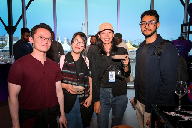 Guests pose for a group photo while holding their food.