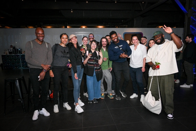 A large group of guests pose for a group photo.