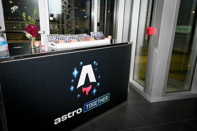 The Astro Together branded registration bar. Sitting atop it are rows of gourmet cookies for guests to take with them as they leave.